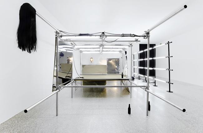 PEPO SALAZAR Untitled Installation (La fiesta de los metales), 2009 Fluorescent tube, stainless steel, 2G, paint, DM, stainless steel sheets, tripods/lamps, wig, botles